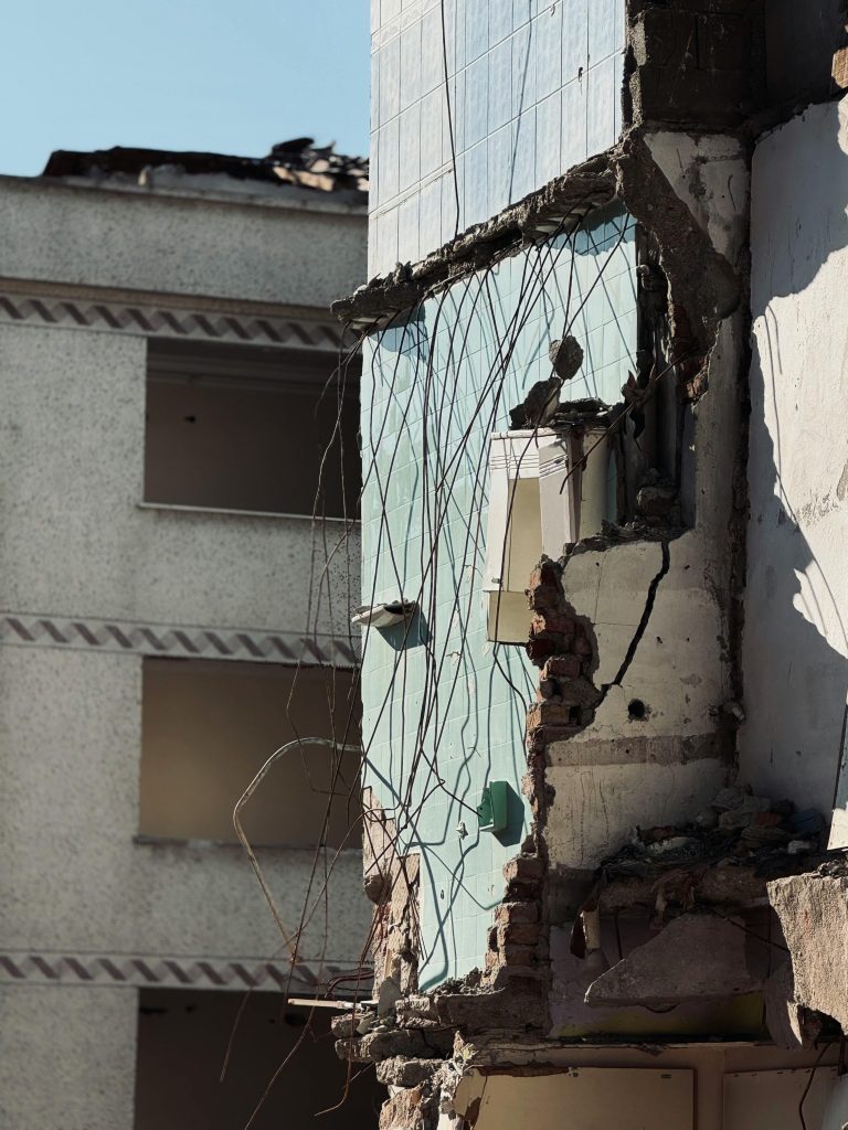 Partially demolished building with a damaged exterior wall, showcasing urban decay.